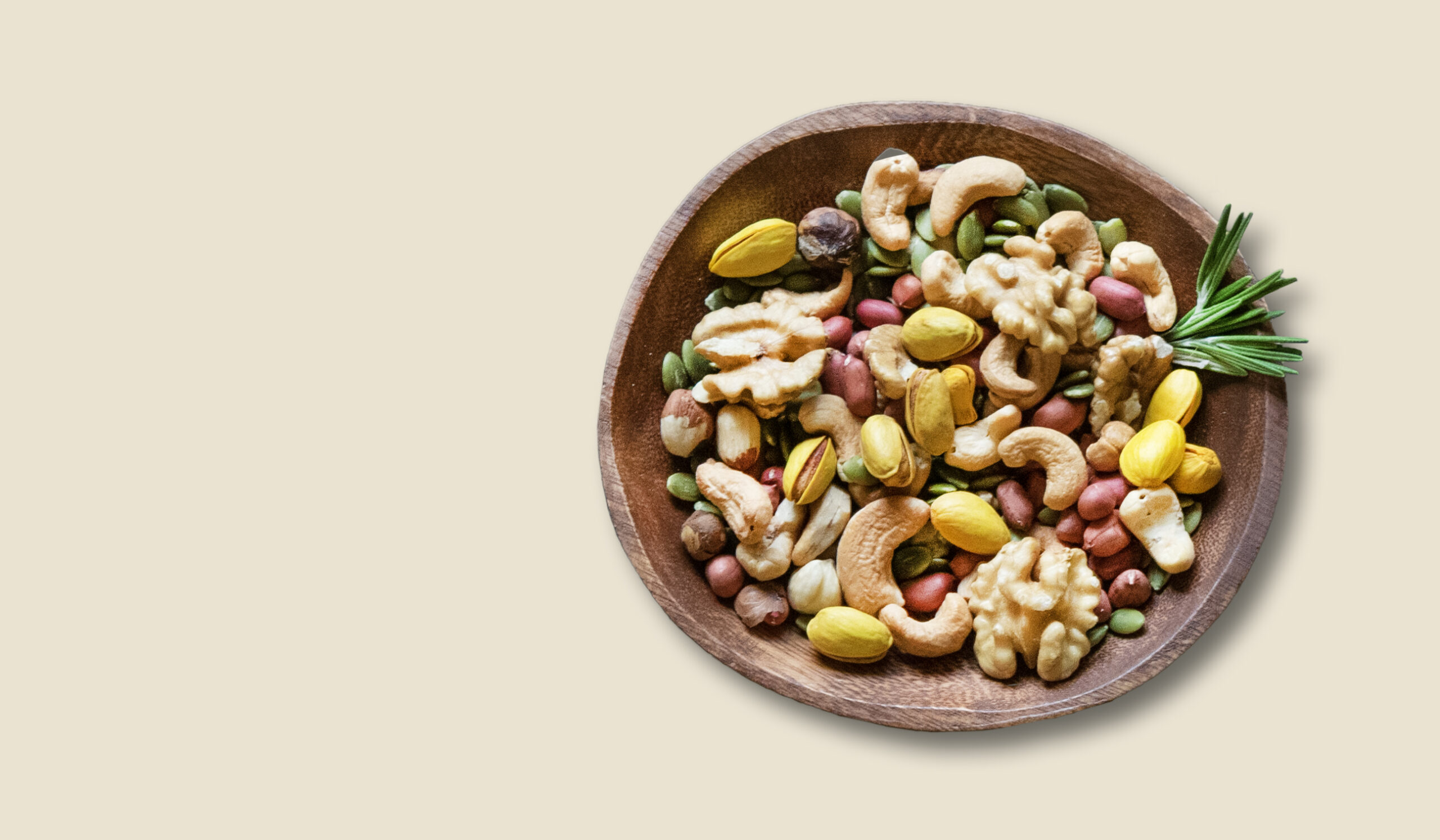 Nuts mix in a wooden bowl on a yellow background. The concept of vegetarian and diet snacks. Top view and copy space.